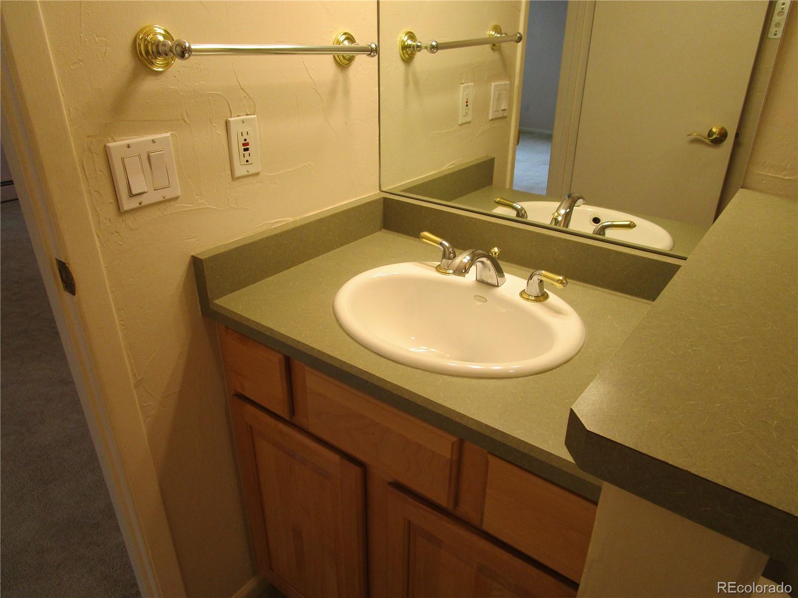 4 Nome Way, Unit A Aurora, CO 80012 - Photo 17 of 22 a bathroom with a sink and a mirror