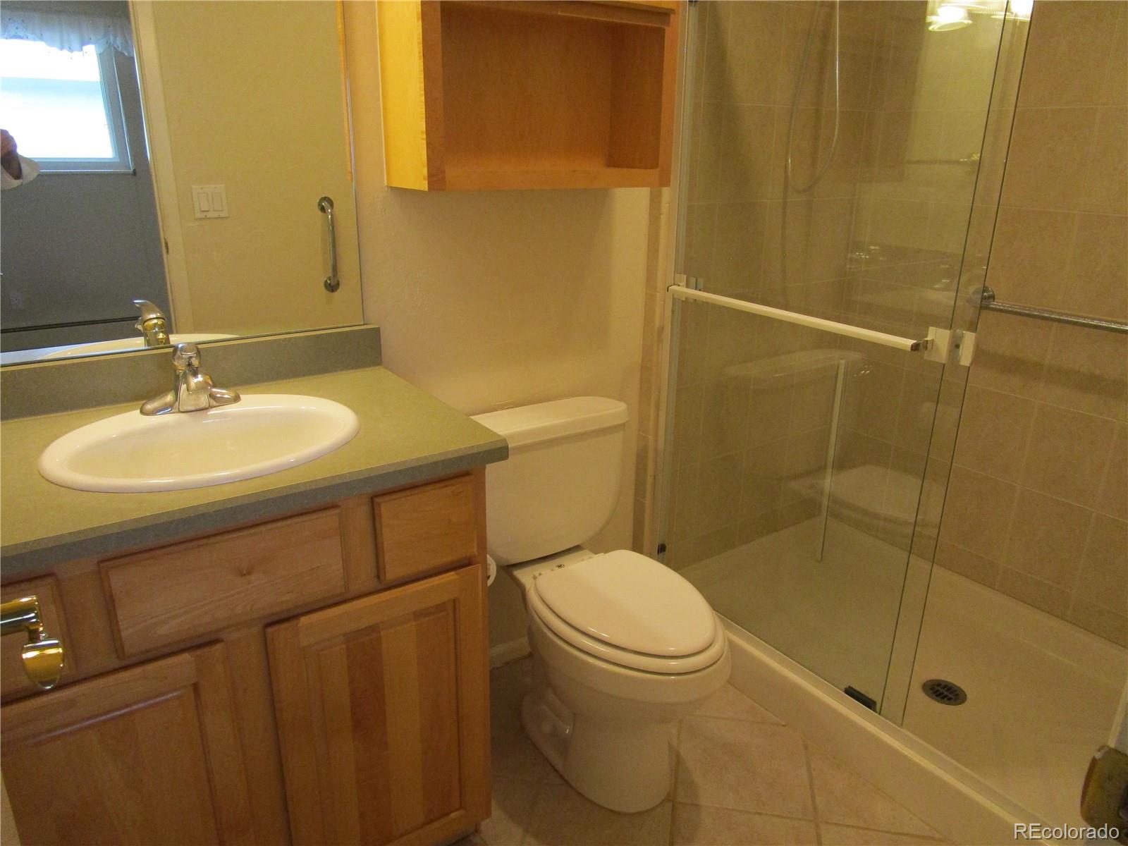 4 Nome Way, Unit A Aurora, CO 80012 - Photo 19 of 22 a bathroom with a sink toilet and shower