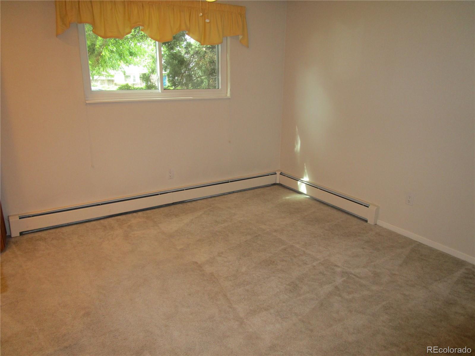 4 Nome Way, Unit A Aurora, CO 80012 - Photo 20 of 22 a view of an empty room with a window