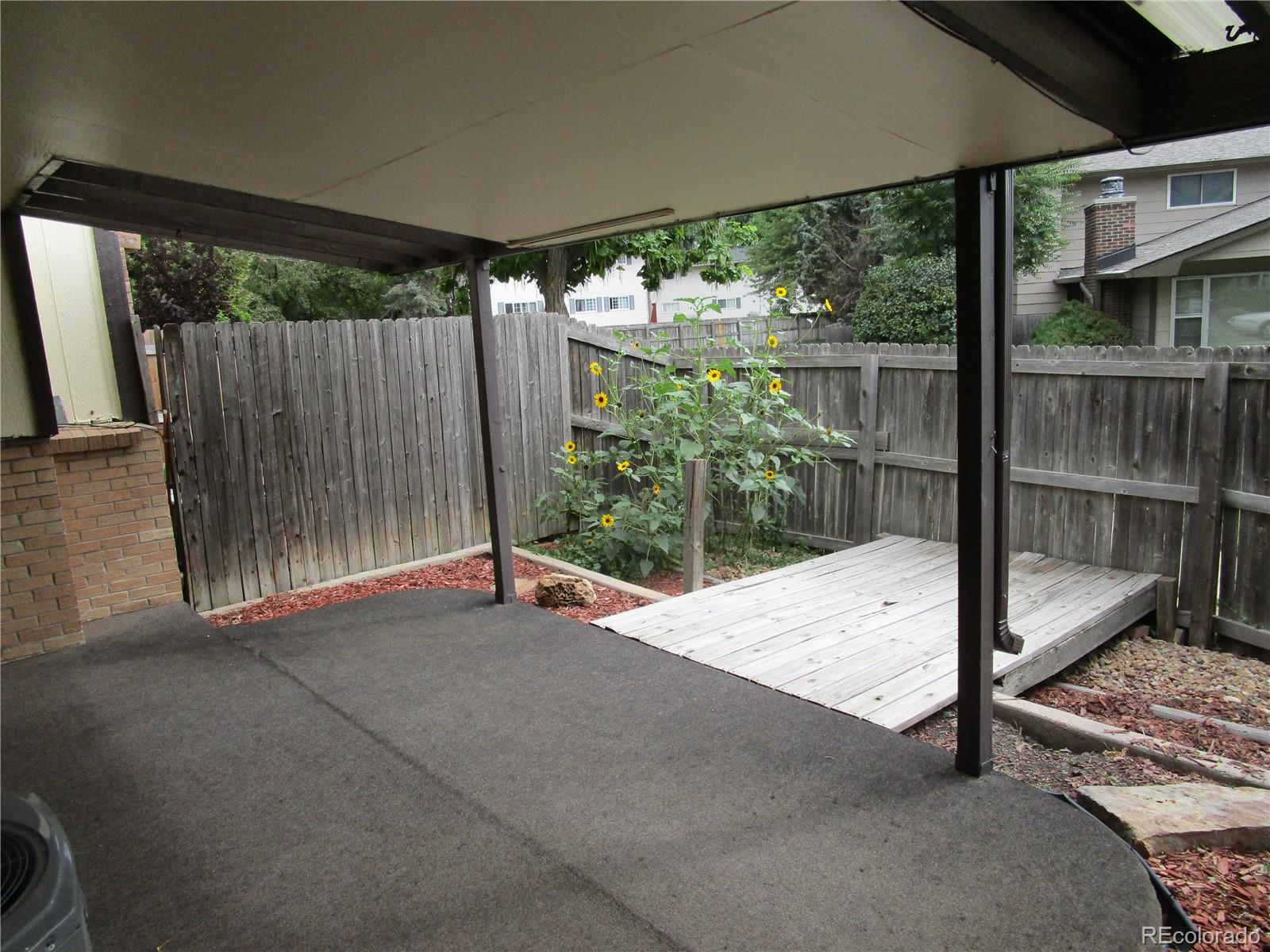 4 Nome Way, Unit A Aurora, CO 80012 - Photo 22 of 22 a bench sitting in front of a building