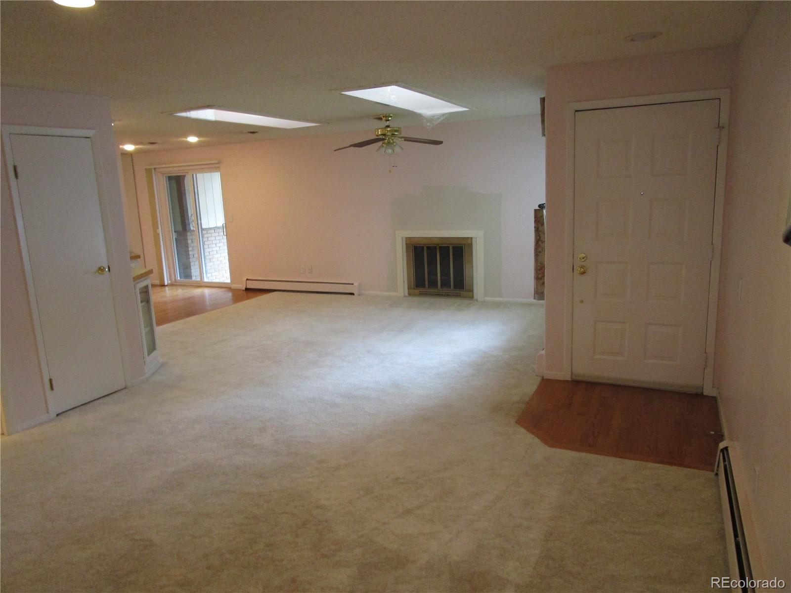 4 Nome Way, Unit A Aurora, CO 80012 - Photo 3 of 22 a view of a livingroom with a fireplace
