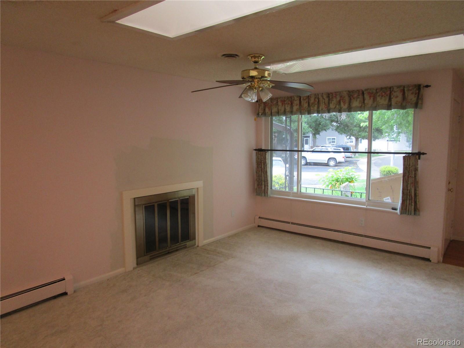 4 Nome Way, Unit A Aurora, CO 80012 - Photo 8 of 22 an empty room with windows and outdoor view