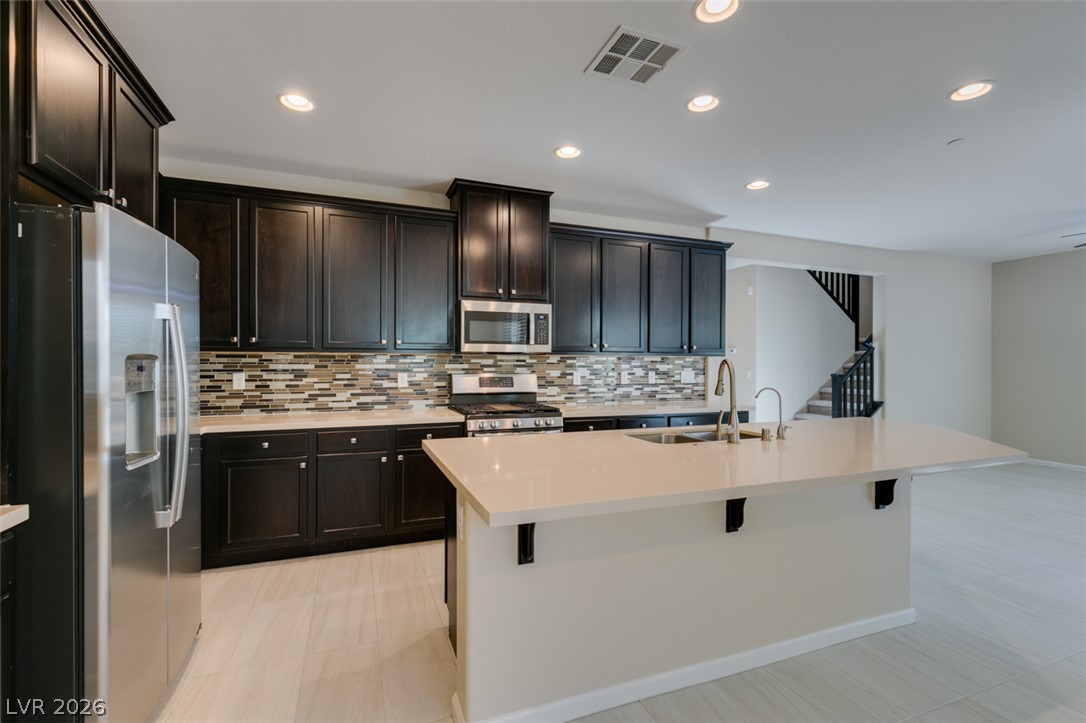 2549 Sable Ridge Street Henderson, NV 89044 - Photo 25 of 48 A well-appointed culinary space featuring sleek cabinetry, lustrous countertops, and modern appliances.