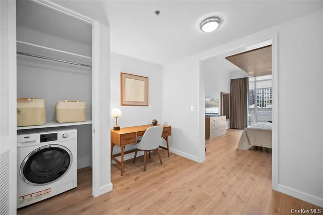 a view of a room with wooden floor cabinet and a bathroom