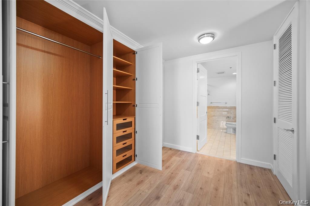 1 Renaissance Square, Unit 10E White Plains, NY 10601 - Photo 16 of 27 a view of walk in closet with empty racks
