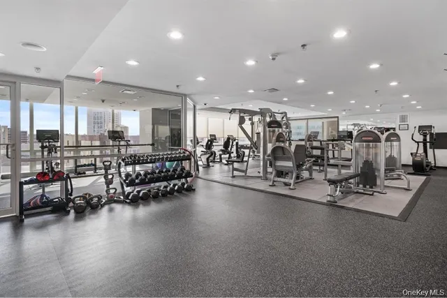 a room with gym equipment and floor to ceiling window