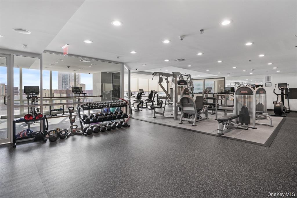 1 Renaissance Square, Unit 10E White Plains, NY 10601 - Photo 22 of 27 a view of a room with gym equipment and mirrors