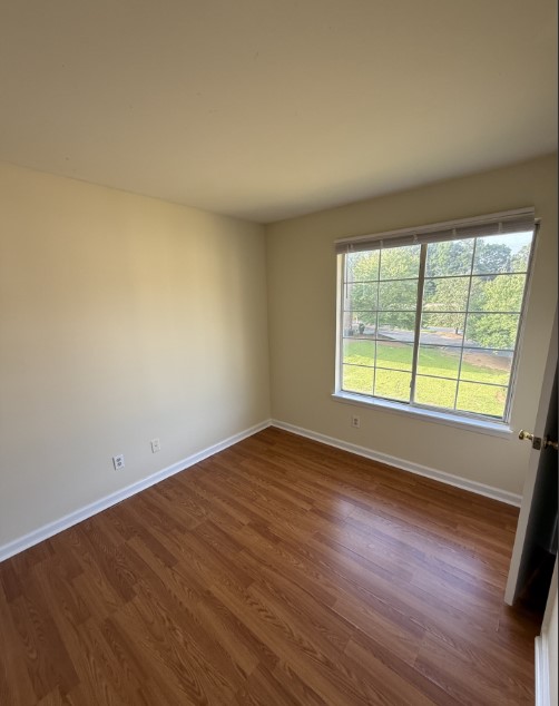 220 Elm Street, Unit 533 Clemson, SC 29631 - Photo 6 of 10 Well-lit room featuring rich wood flooring and a refreshing outdoor view.