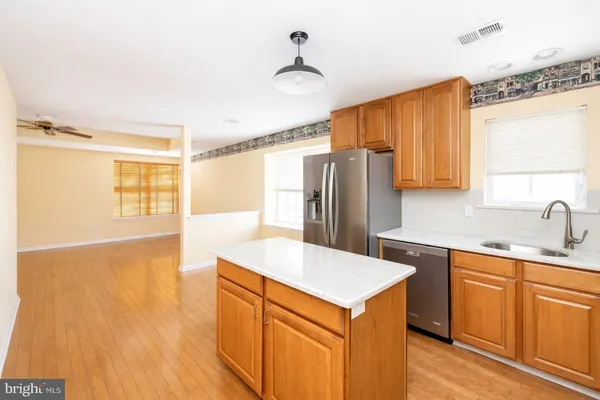 a kitchen with stainless steel appliances a refrigerator and a sink