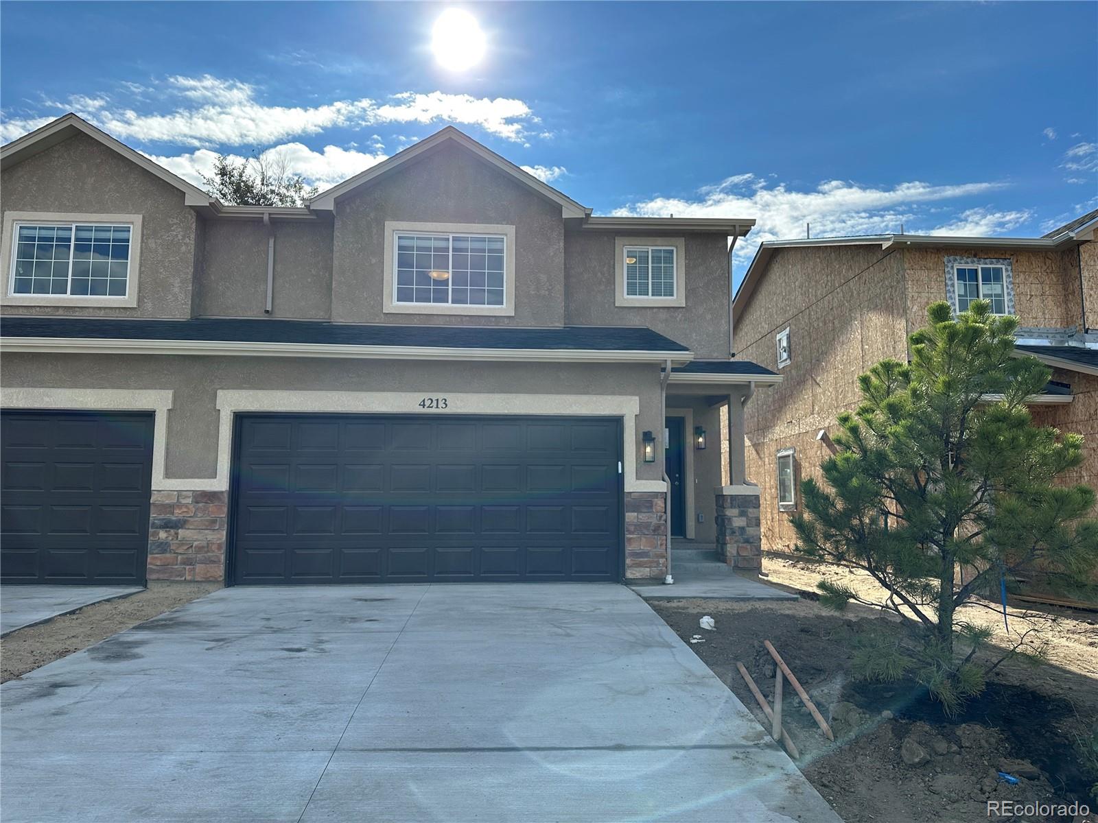 a front view of a house with a yard and garage