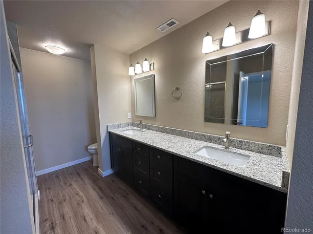 a bathroom with a double vanity sink and a mirror