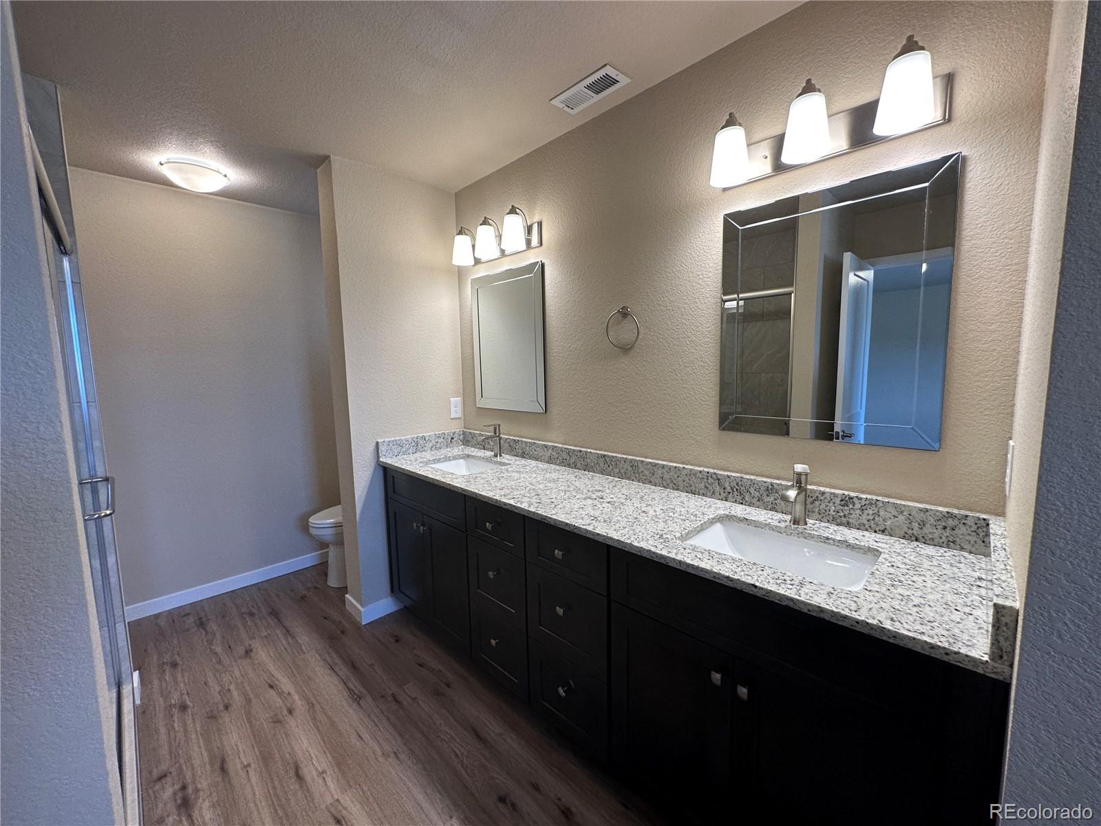 4213 Date Street Colorado Springs, CO 80917 - Photo 12 of 20 a bathroom with a double vanity sink and a mirror