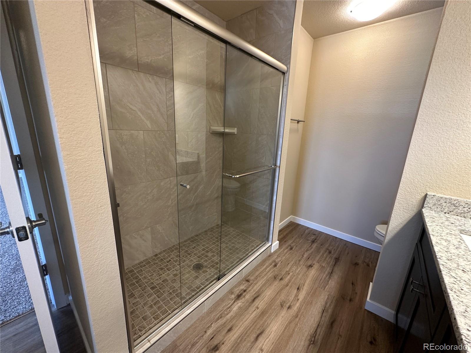 4213 Date Street Colorado Springs, CO 80917 - Photo 13 of 20 a bathroom with a shower and a sink