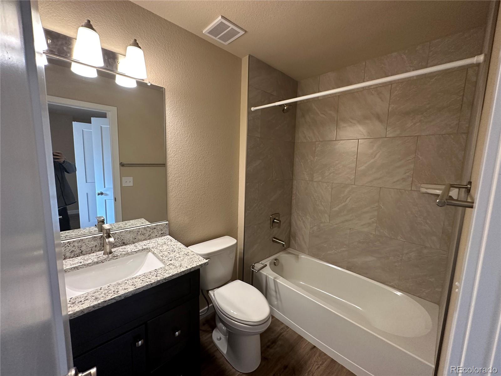 4213 Date Street Colorado Springs, CO 80917 - Photo 18 of 20 a bathroom with a granite countertop sink toilet and shower