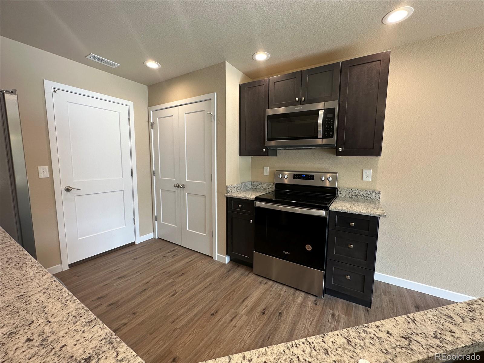 4213 Date Street Colorado Springs, CO 80917 - Photo 6 of 20 a kitchen with a refrigerator and a stove top oven