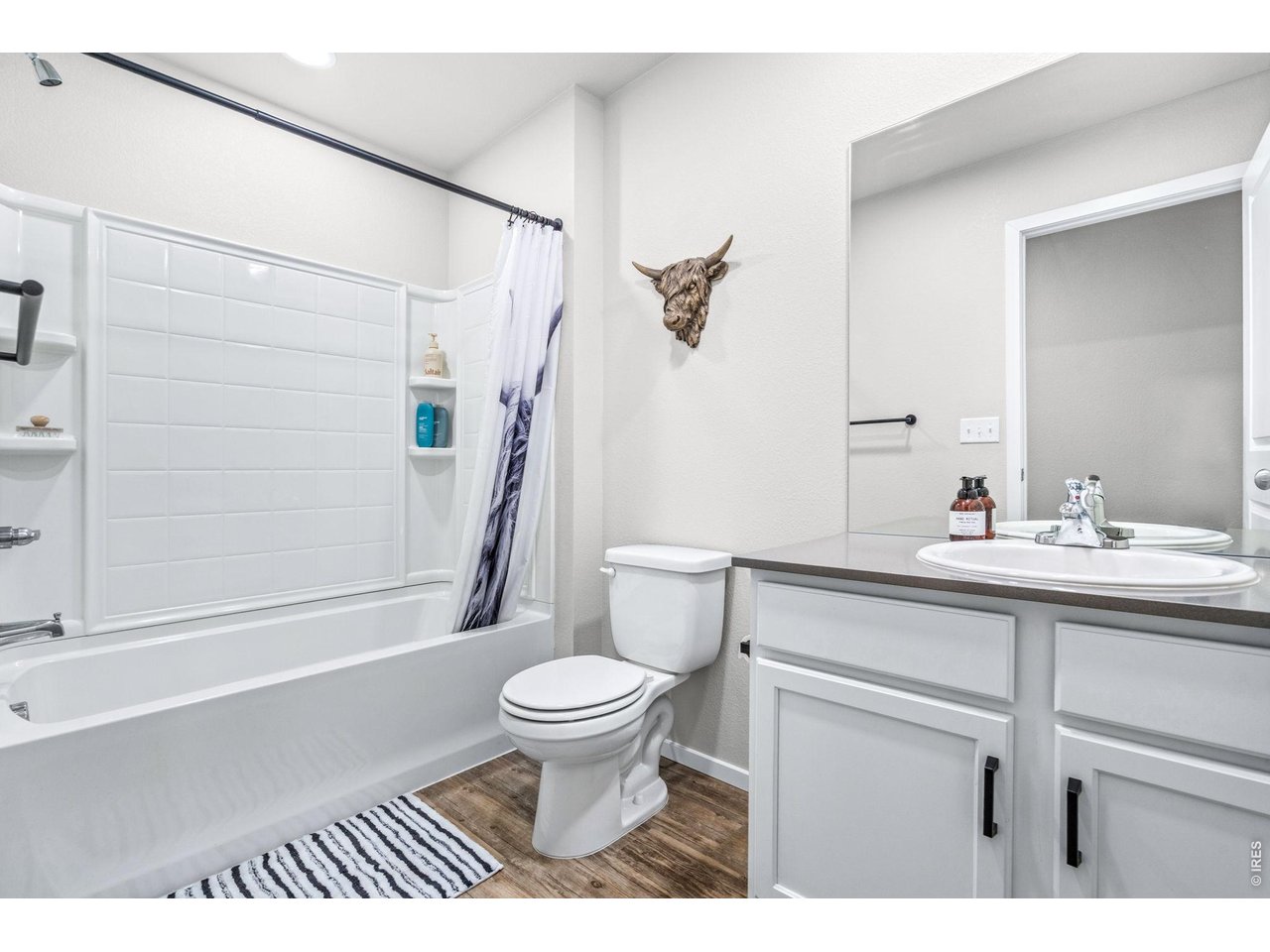 6609 West 4th Street Road, Unit 1 Greeley, CO 80634 - Photo 13 of 23 a bathroom with a sink a toilet and shower