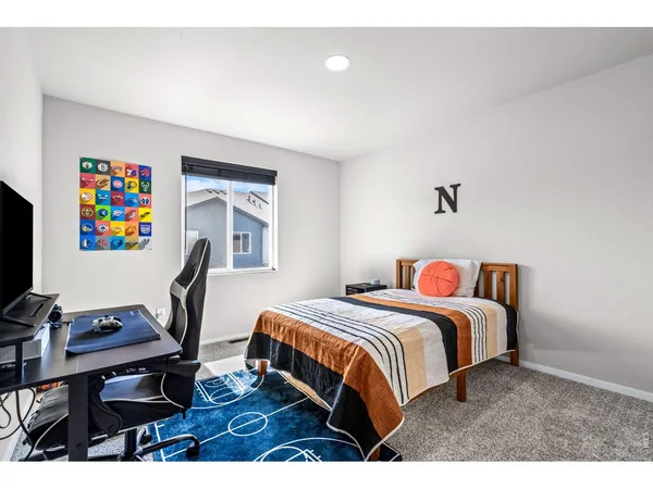 a bedroom with furniture and a window