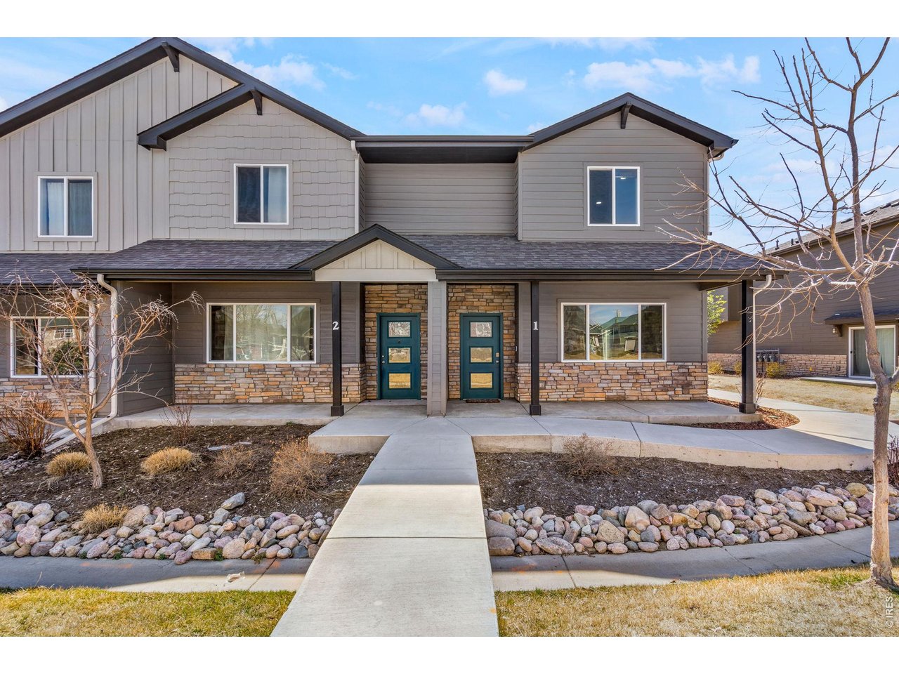 6609 West 4th Street Road, Unit 1 Greeley, CO 80634 - Photo 2 of 23 a front view of a house with a yard