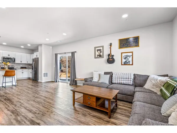 a living room with furniture and kitchen view
