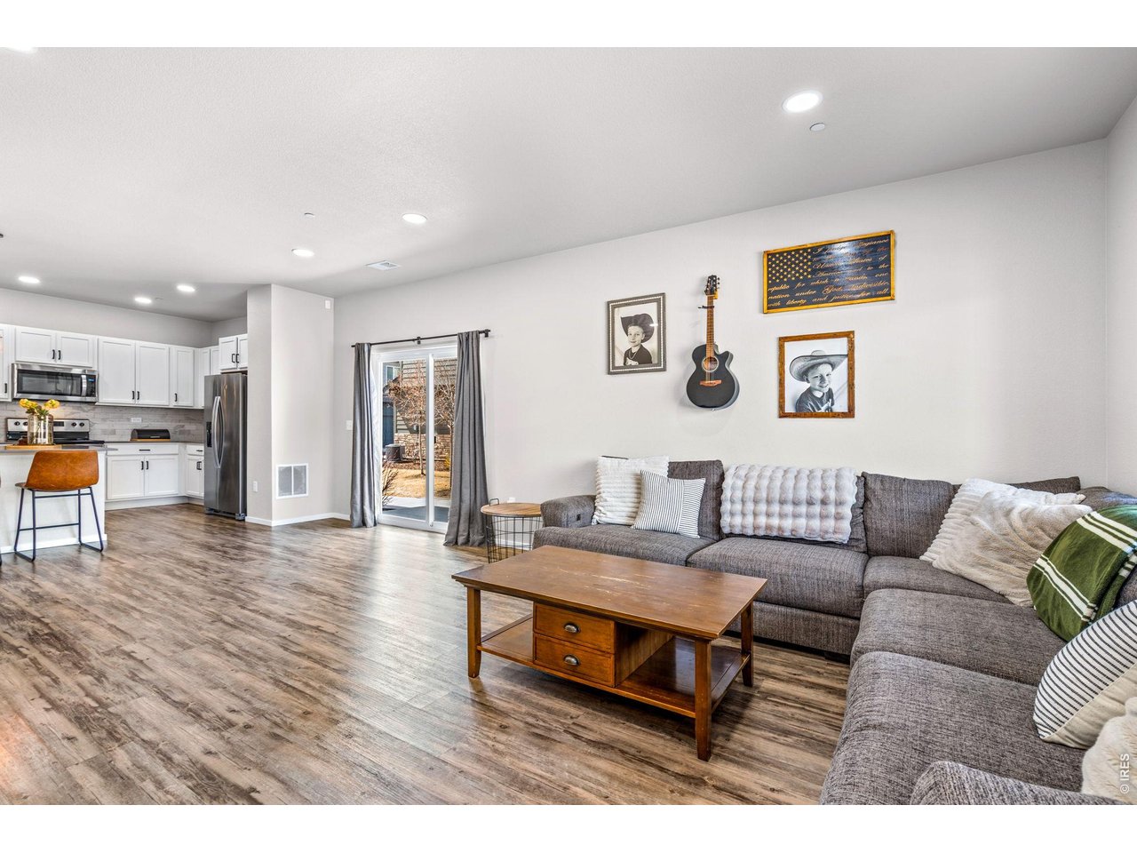 6609 West 4th Street Road, Unit 1 Greeley, CO 80634 - Photo 3 of 23 a living room with furniture and kitchen view
