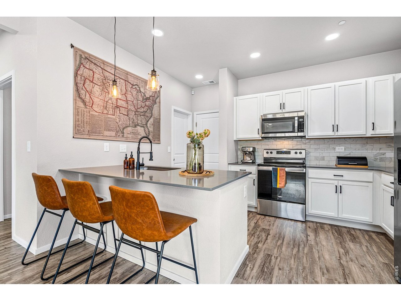 6609 West 4th Street Road, Unit 1 Greeley, CO 80634 - Photo 5 of 23 a kitchen with stainless steel appliances kitchen island granite countertop a sink and cabinets