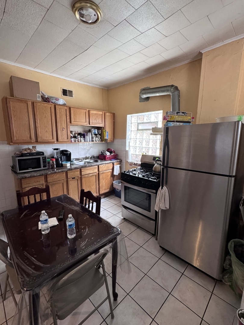 1940 North Pulaski Road Chicago, IL 60639 - Photo 17 of 33 a kitchen with a sink appliances and cabinets
