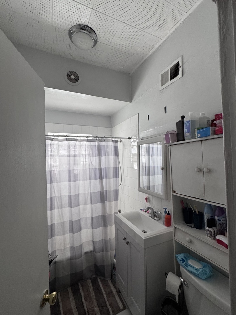 1940 North Pulaski Road Chicago, IL 60639 - Photo 25 of 33 a bathroom with a sink a toilet and shower