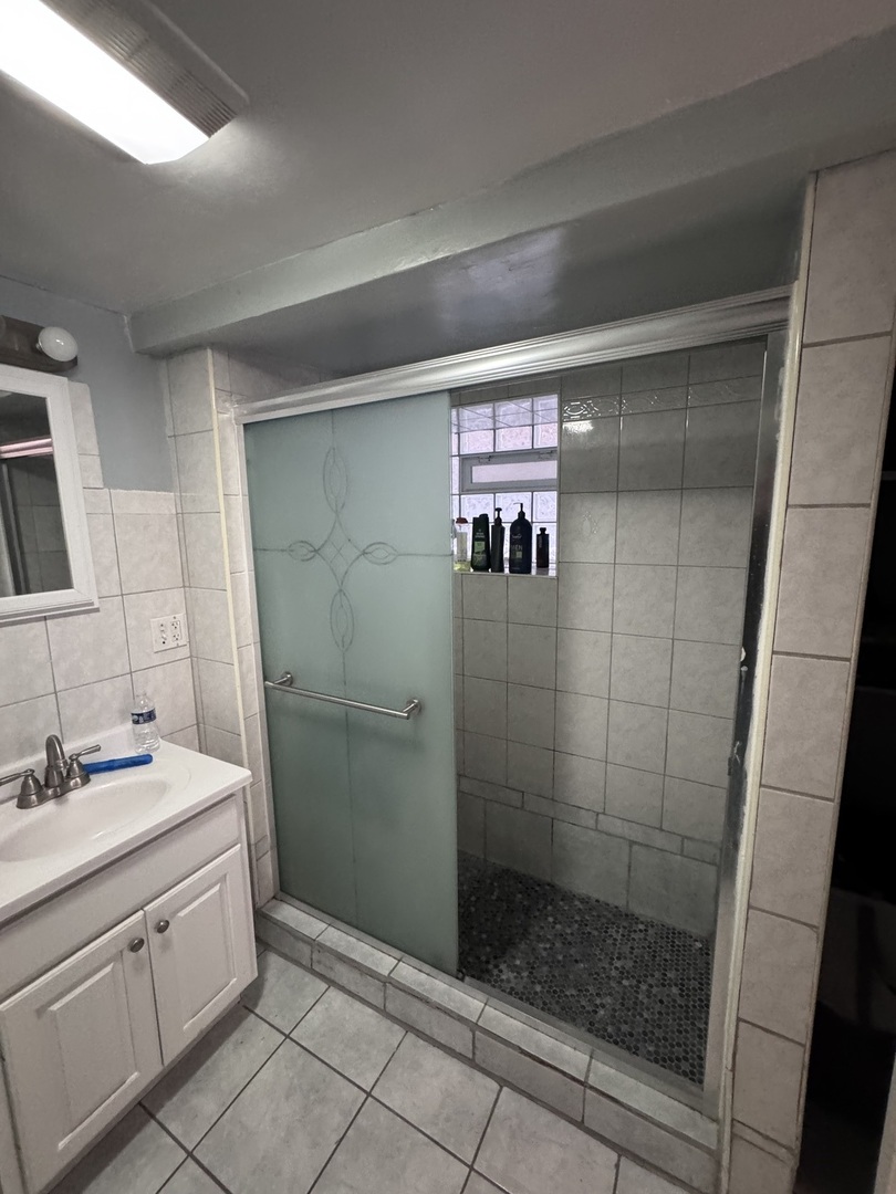 1940 North Pulaski Road Chicago, IL 60639 - Photo 27 of 33 a bathroom with a shower toilet and sink
