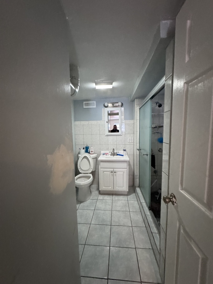 1940 North Pulaski Road Chicago, IL 60639 - Photo 29 of 33 a bathroom with a sink a toilet and shower