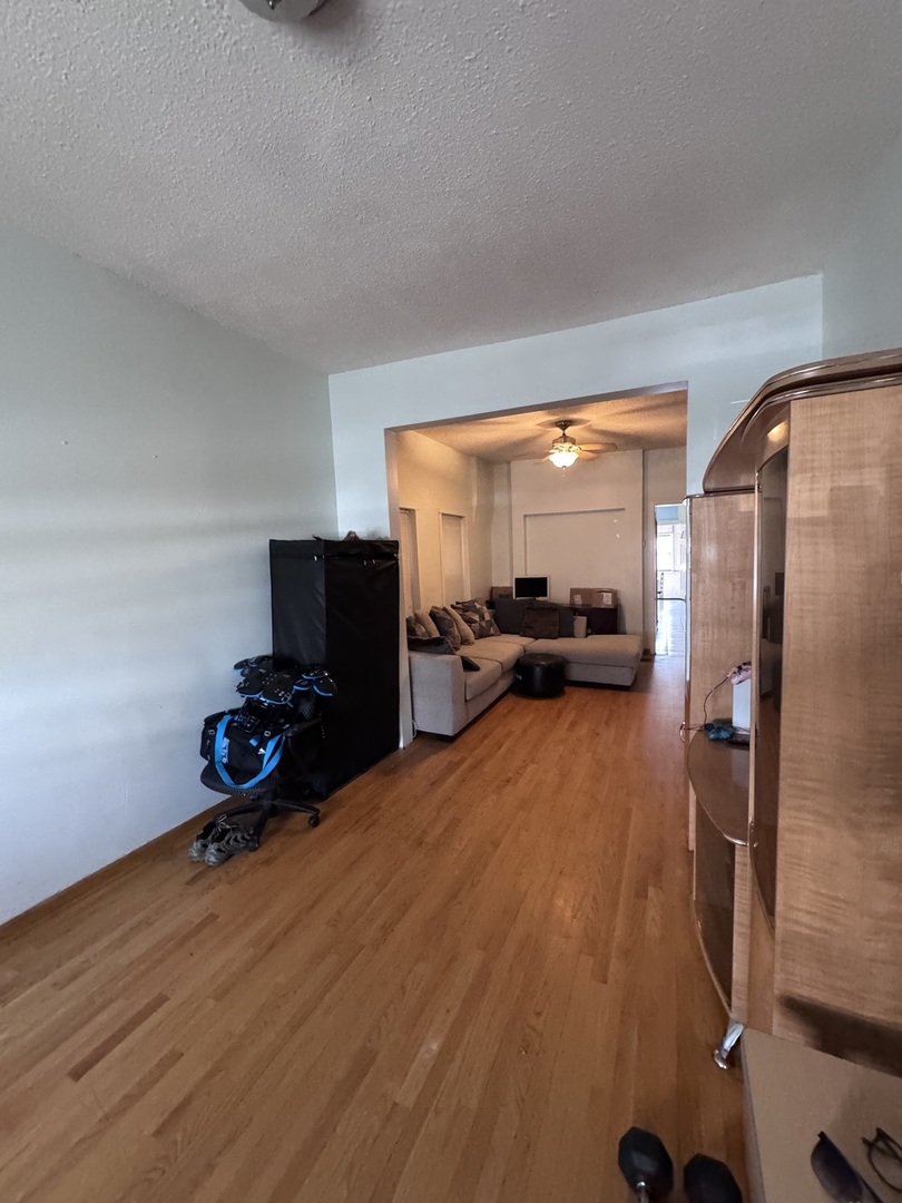 1940 North Pulaski Road Chicago, IL 60639 - Photo 7 of 33 a bedroom with a bed and a flat tv screen on wall