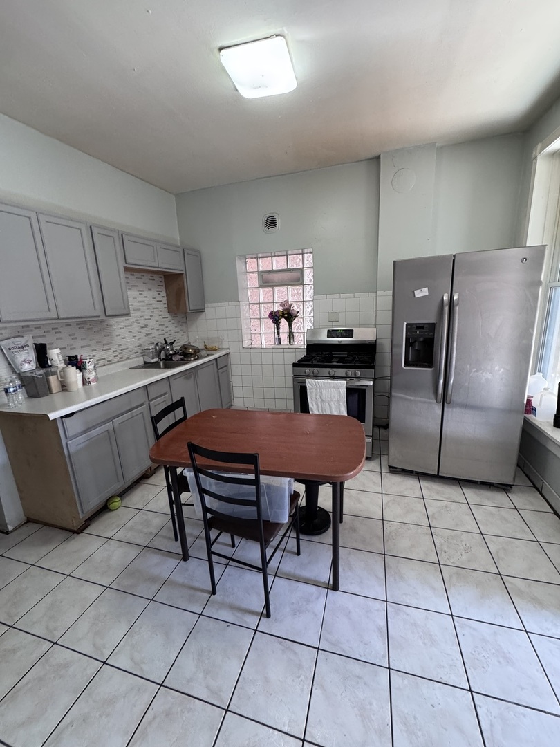 1940 North Pulaski Road Chicago, IL 60639 - Photo 10 of 33 a kitchen with stainless steel appliances a stove a sink a counter top space and cabinets