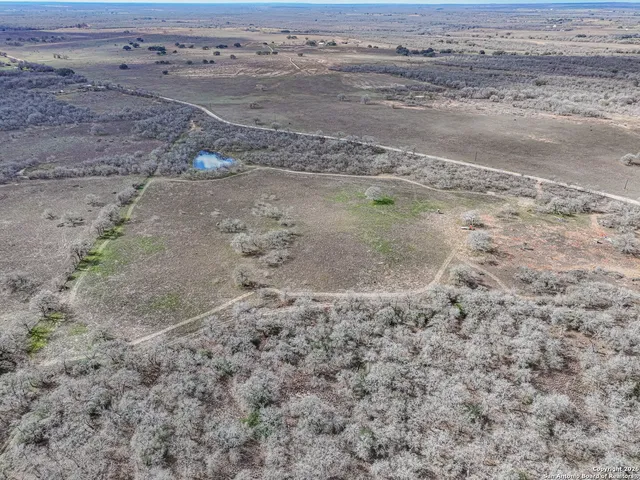 a view of a dirt road with wooden floor