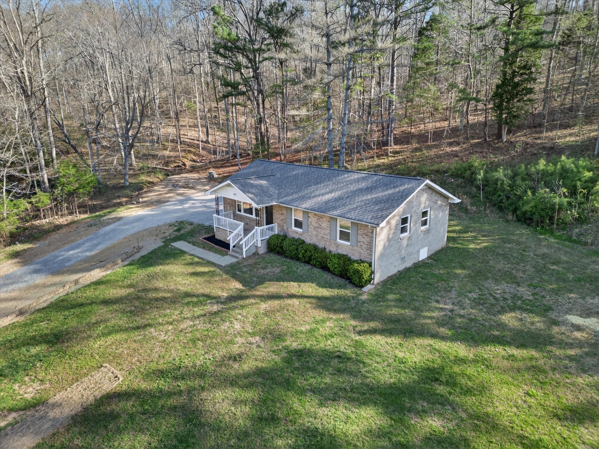 a view of a house with a yard and tree s