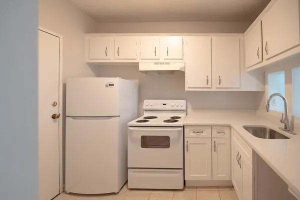 a white refrigerator freezer sitting inside of a kitchen