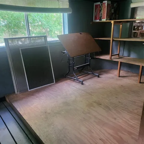 a view of a room with furniture and a window