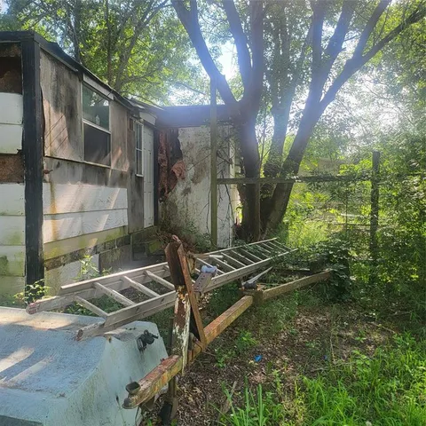 a backyard of a house with table and chairs