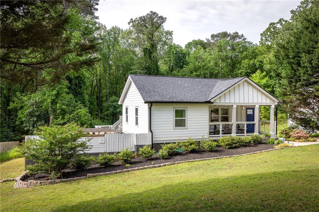 a front view of a house with a yard and trees