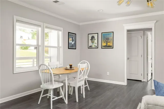 a dining room with furniture and wooden floor