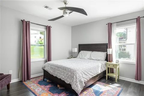 a bedroom with a bed lamp and a window