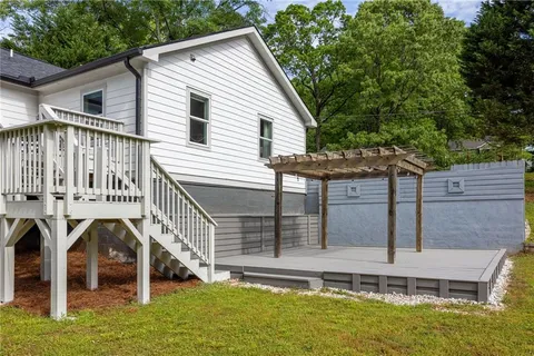 a view of a house with pool and chairs