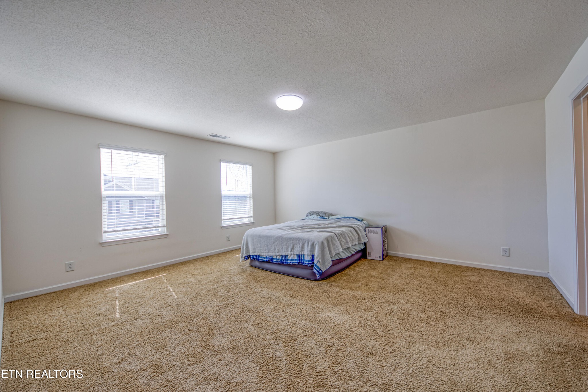 187 Ibis Loop Oak Ridge, TN 37830 - Photo 16 of 21 a spacious bedroom with a bed and a window