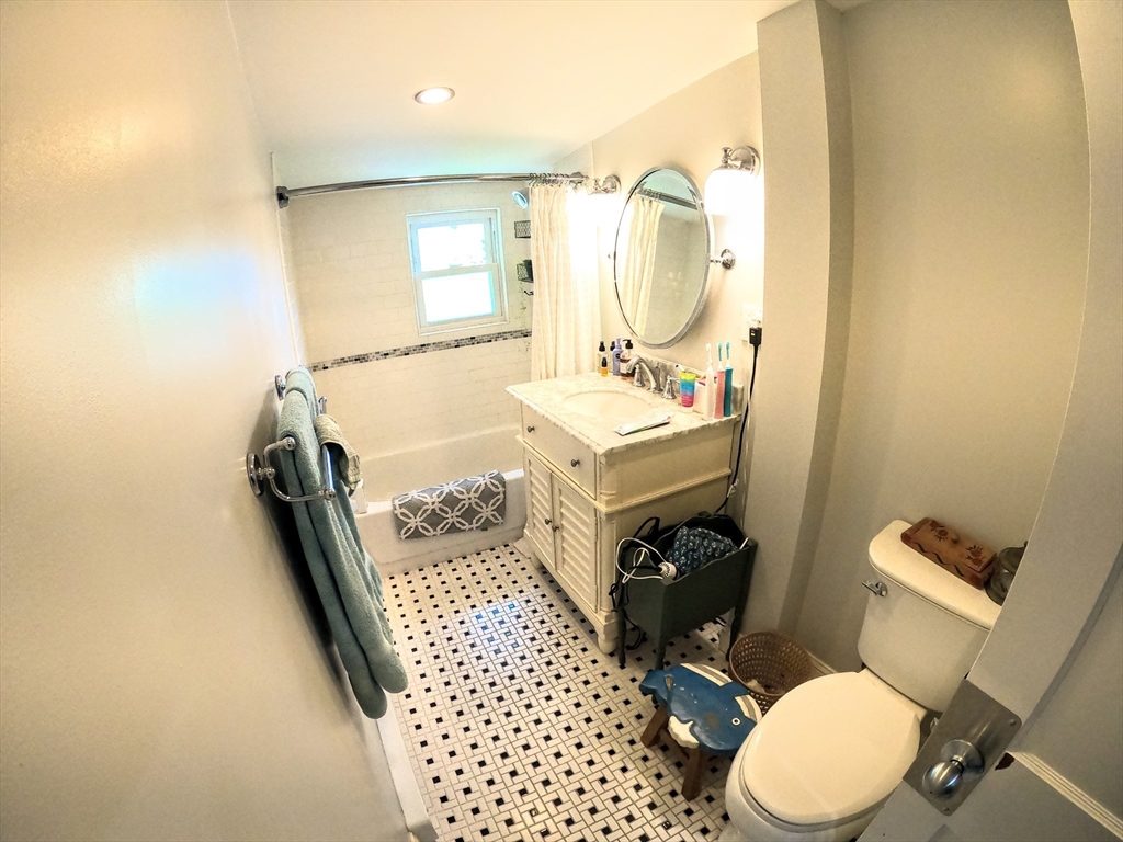 12 Searle Road, Unit 12 Boston, MA 02132 - Photo 26 of 35 a bathroom with a sink toilet vanity and mirror