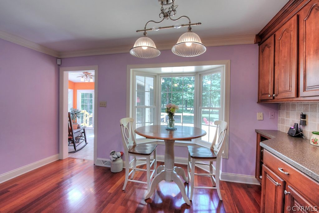 13860 West Salisbury Road Midlothian, VA 23113 - Photo 16 of 40 a view of a dining room with furniture wooden floor and chandelier