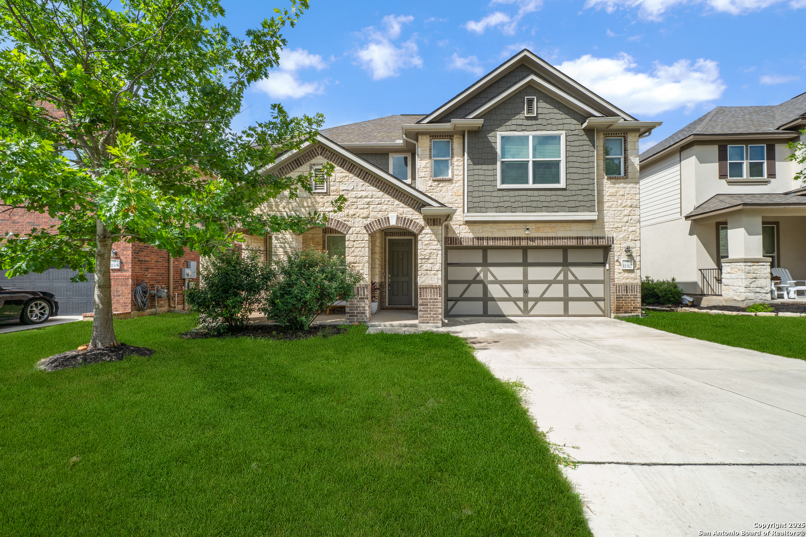 a front view of a house with a yard and garage