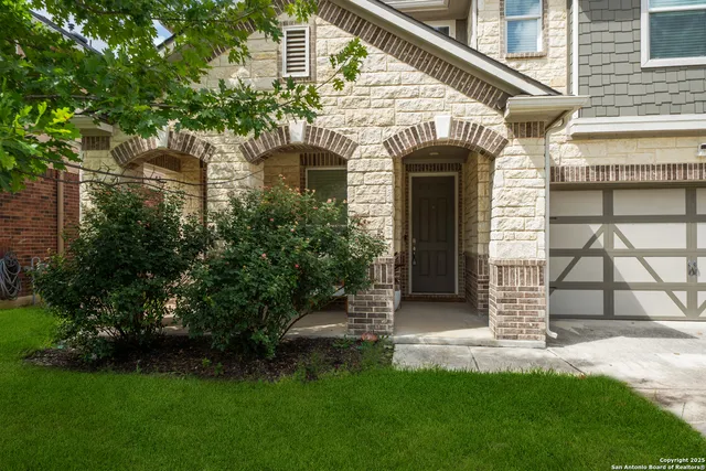 a front view of a house with a garden and plants