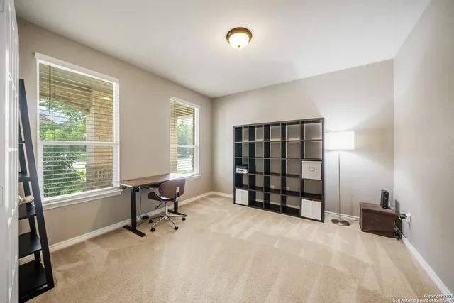 a view of workspace with furniture and a window