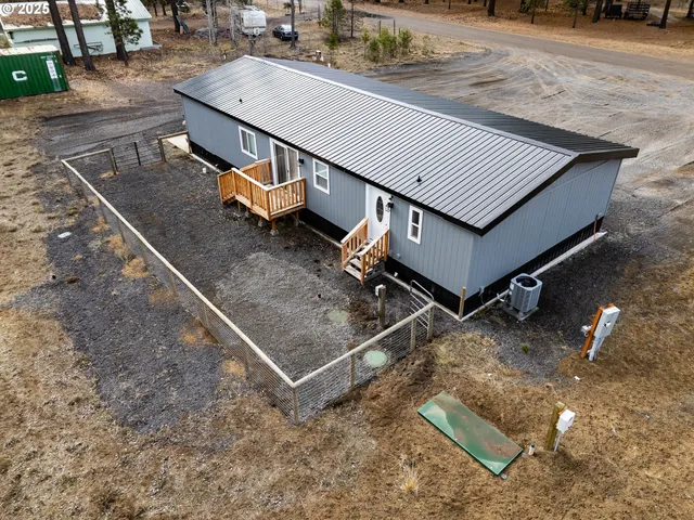a view of a house with a yard and sitting area