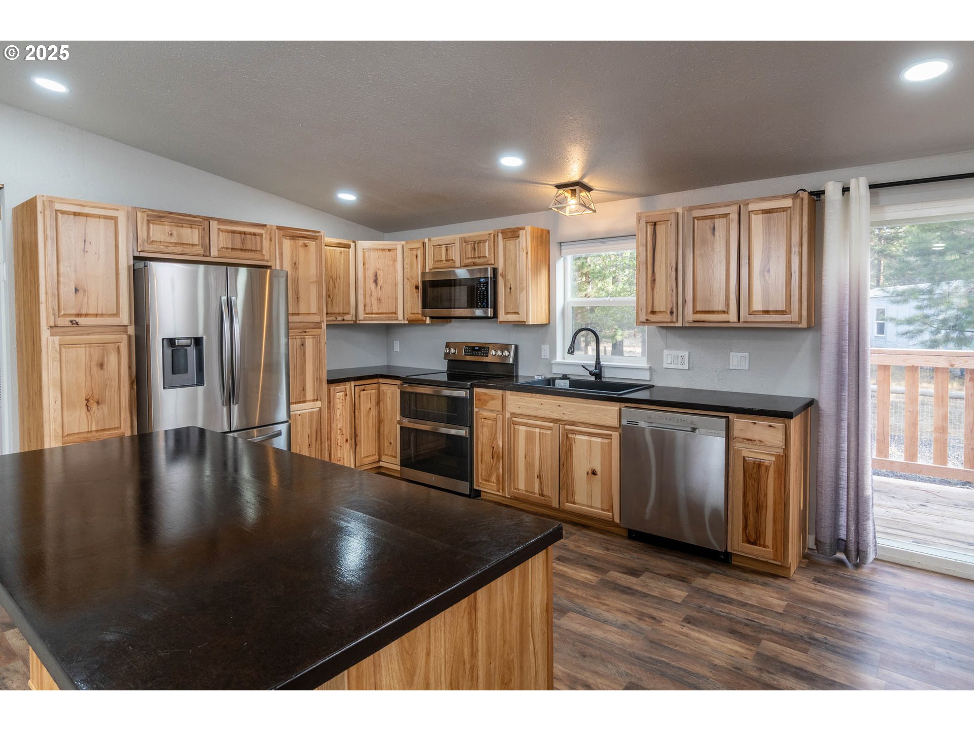 51488 Hann Road La Pine, OR 97739 - Photo 17 of 30 a kitchen with stainless steel appliances granite countertop a refrigerator a sink a stove a microwave and island
