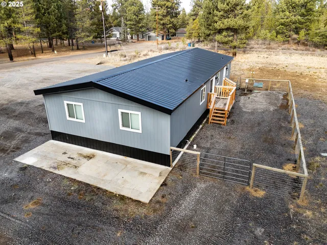 a view of a roof deck with wooden floor and a yard