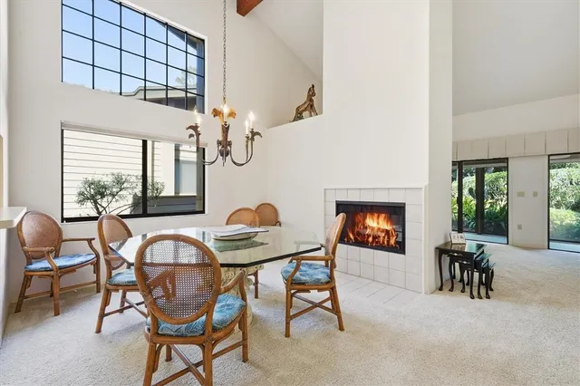 a view of a dining room with furniture a rug and wooden floor